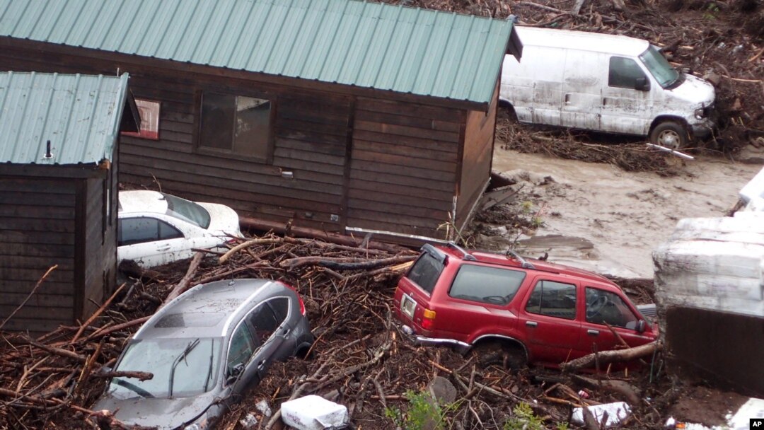 Cabins and vehicles are swept away by storm runoff at El Capitan Canyon Resort & Campground in Gaviota, Calif., Jan. 20, 2017.