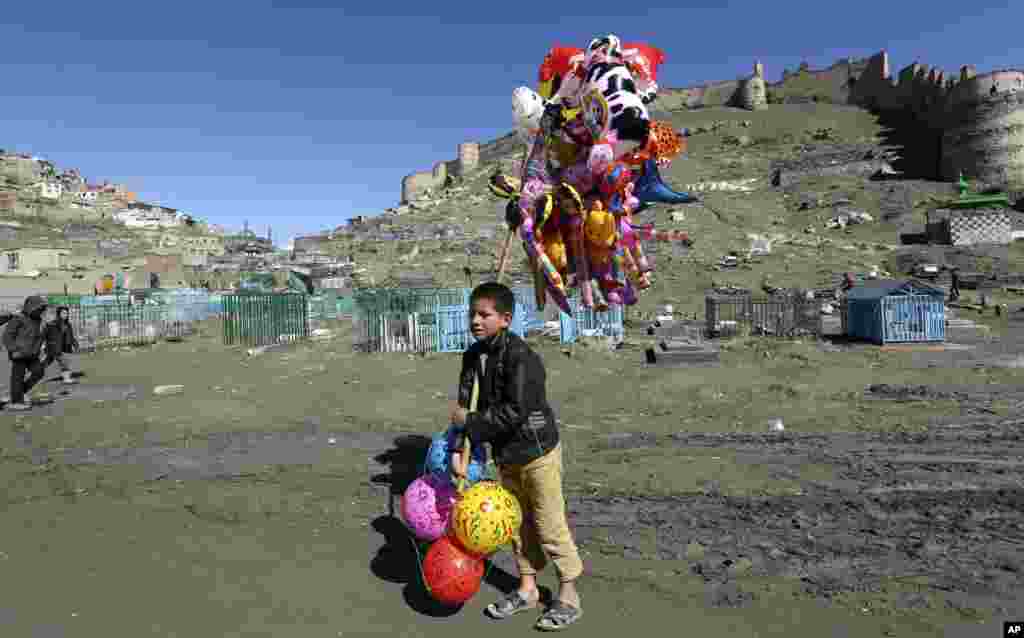 A young boy sells balloons in Kabul, Afghanistan.