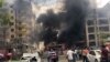 FILE - People watch after a Kurdish rebel suicide bomber detonated an explosives-laden vehicle outside a police headquarters in Midyat, near Turkey's border with Syria, June 8, 2016.