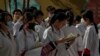 北京的中学生在进入高考考场前温习功课。（2023年6月7日）
