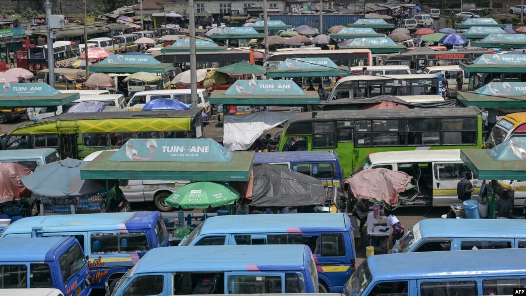 FILE - Kenyan public transport, known locally as matatu, queue to transport passengers in Nairobi, Sept. 12, 2023. 