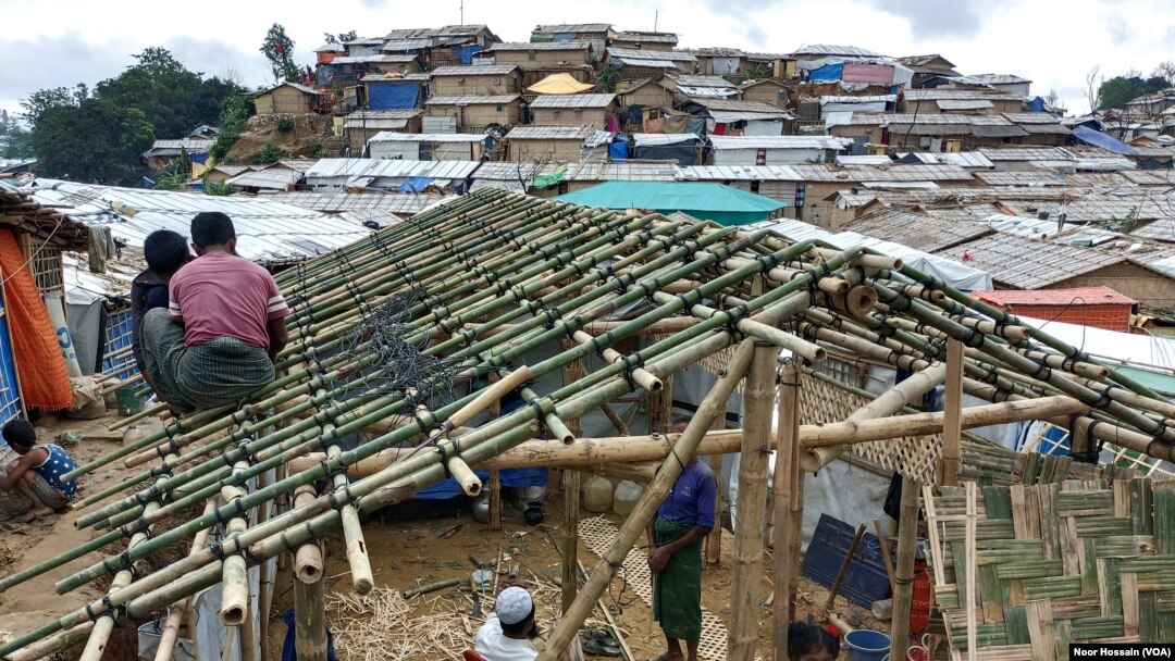 FILE - Rohingya refugees build a bamboo-and-tarpaulin shack in Balukhali camp, Cox's Bazar district, Bangladesh. Over 1 million Rohingya refugees live in camps in Bangladesh.