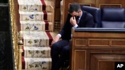 FILE - Spain's Prime Minister Pedro Sanchez listens to a speech by Vox party leader Santiago Abascal during a parliamentary session in Madrid, Spain, Oct. 21, 2020.