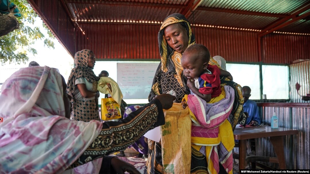 FILE - A handout photograph, shot in January 2024, shows a woman and baby at the Zamzam displacement camp, close to El Fasher in North Darfur, Sudan. (MSF/Mohamed Zakaria/Handout via Reuters)