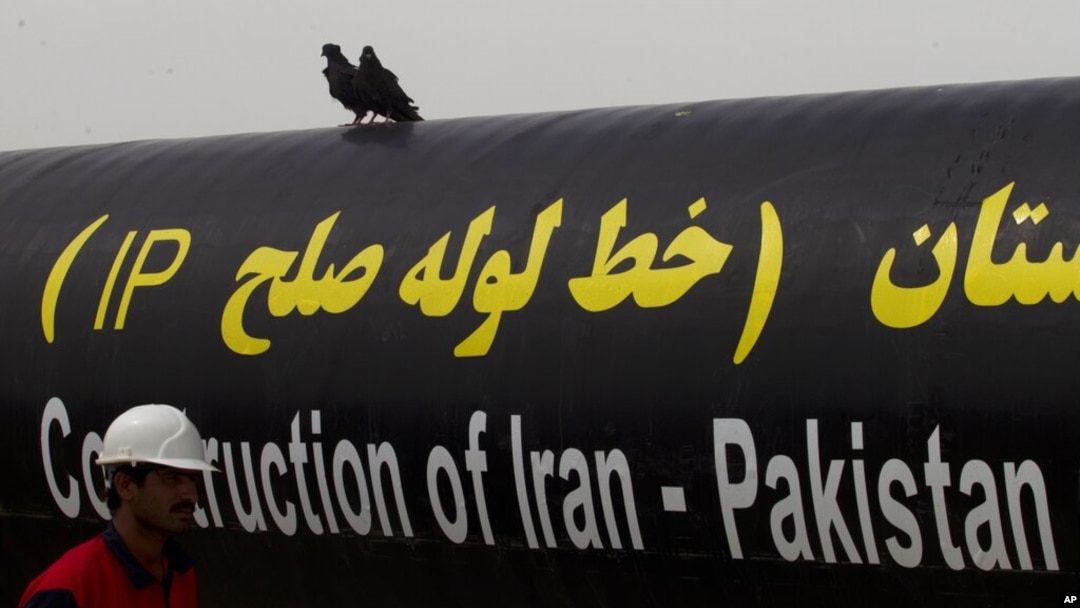 FILE - An Iranian worker walks past the Pakistan-Iran Gas Pipeline Project in Gabd near the Pakistani border in Iran, March 11, 2013.
