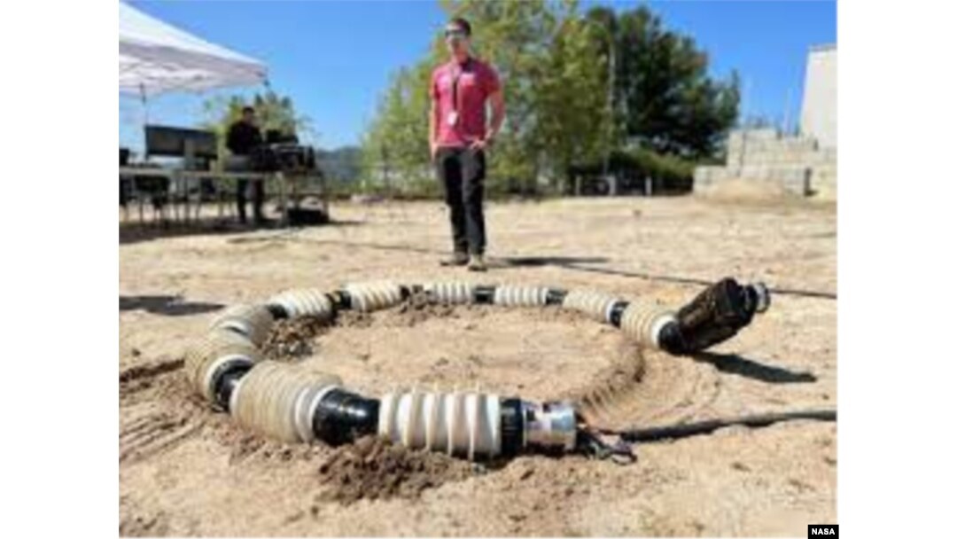 EELS is tested in the sandy terrain of JPL's Mars Yard in April. Engineers repeatedly test the snake-like robot across a variety of terrain, including sand, snow and ice. (Photo Credit: NASA/JPL-Caltech)