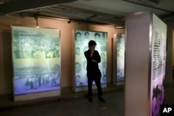 FILE - A visitor looks at an exhibit during the inauguration of a memorial to victims of Mexico's "dirty war" at the former Federal Security headquarters where protesters were taken in 1971 following a violent crackdown in Mexico City, June 10, 2019.