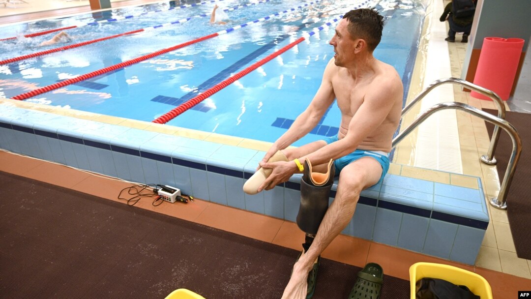 An athlete rests during a swimming event during the qualifying round of the Ukrainian Invictus Games, in the western Ukrainian city of Lviv on April 30, 2023.