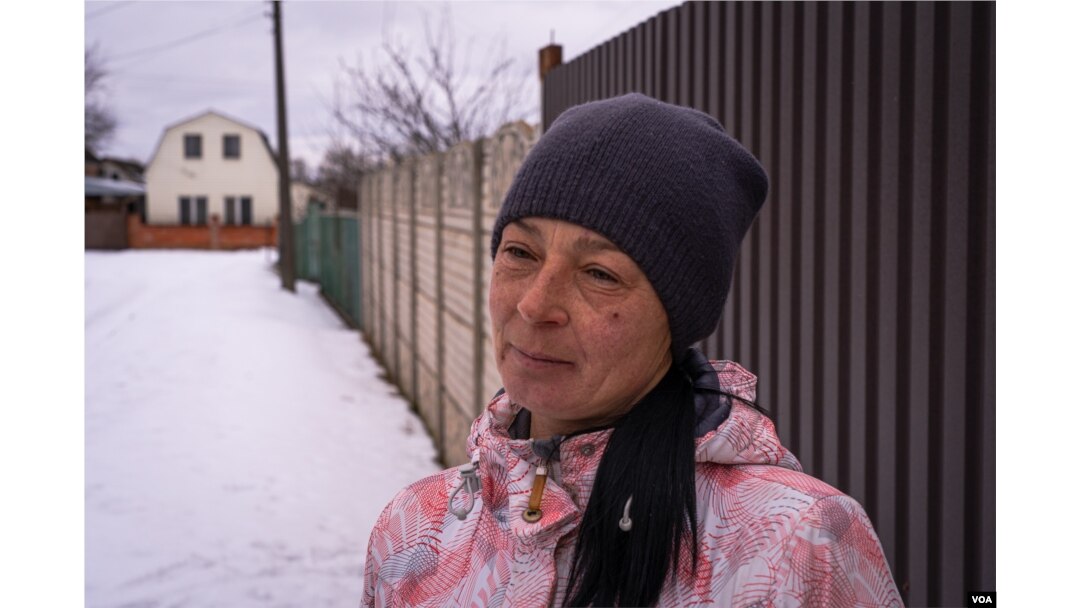 Ludmila speaks in Nova Kozacha, Ukraine, Feb. 14, 2023. Her husband has been in Russia since August when the shrapnel of a bomb injured him. She says he wants to come back, but it is impossible to cross the border. (Yan Boechat/VOA)