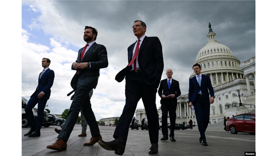 FILE - U.S. senators walk to a press conference to call on U.S. President Joe Biden to negotiate with Republicans in order to make a deal on raising the debt ceiling on Capitol Hill in Washington, May 3, 2023.