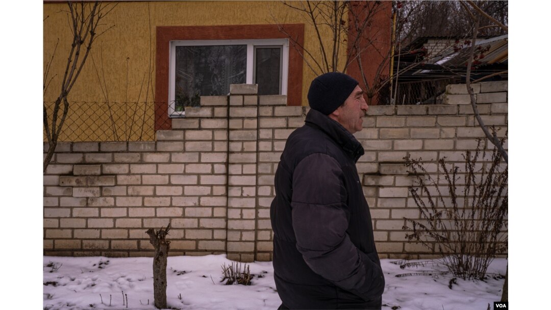 Oleg Moloskniy, 58, walks through Nova Kozacha, Ukraine, Feb. 14, 2023. He lost contact with his relatives in Russia since the beginning of the war, and says their relationship is now over. (Yan Boechat/VOA)