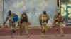 FILE - This undated photo provided by the French military shows three Russian mercenaries in northern Mali. Mali and its neighbors have long battled an Islamic extremist insurgency. Ruling juntas have turned to Russia's mercenary units for security assistance.