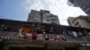 People look out from a common balcony of a Chawl, home to hundreds of families, during a 21-day nationwide lockdown to slow the spreading of coronavirus disease (COVID-19), in Mumbai, India, March 31, 2020.