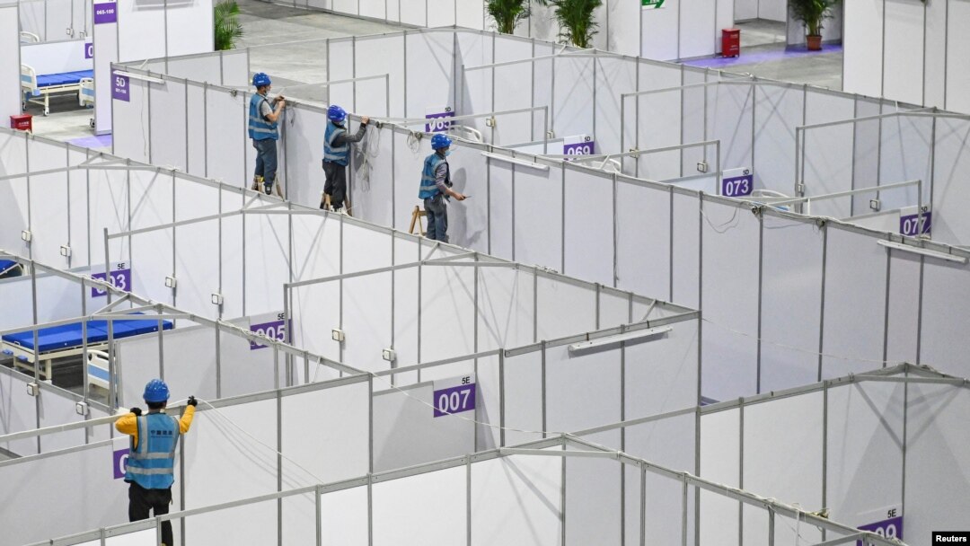 FILE - Workers set up equipment inside Pazhou International Convention Exhibition Center to convert it into a makeshift hospital, in Guangzhou, Guangdong province, China, April 10, 2022. 