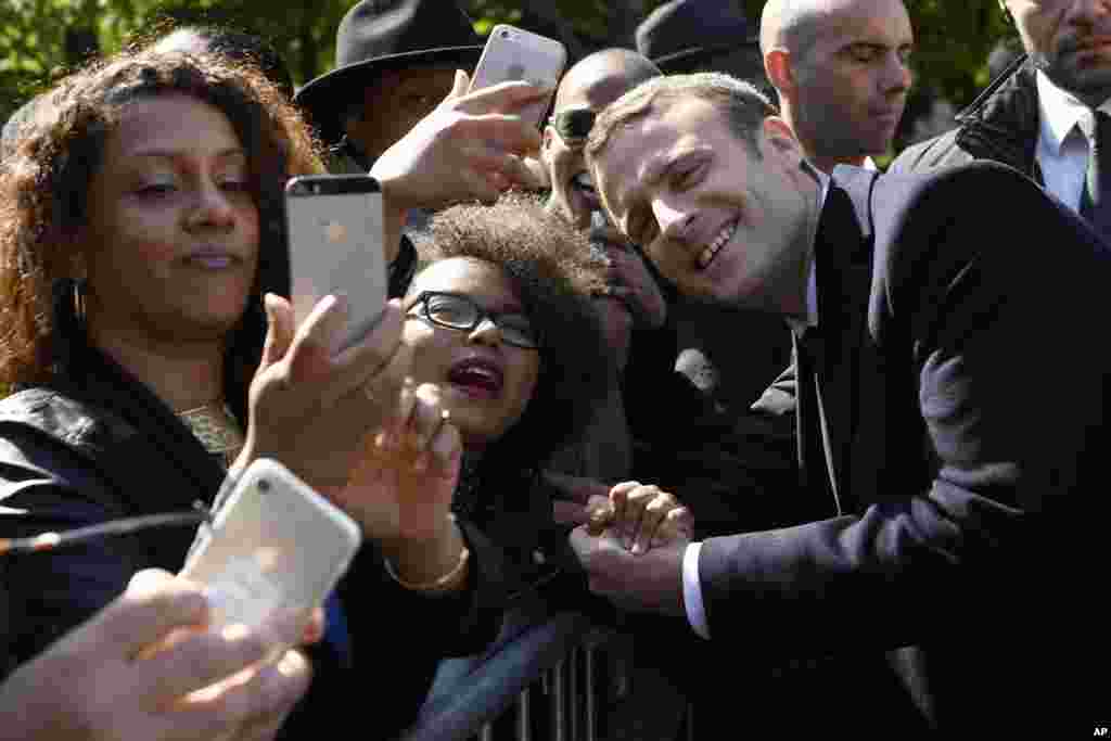 President-elect Emmanuel Macron poses for a picture with supporters after a ceremony to mark the anniversary of the abolition of slavery in Paris, France.
