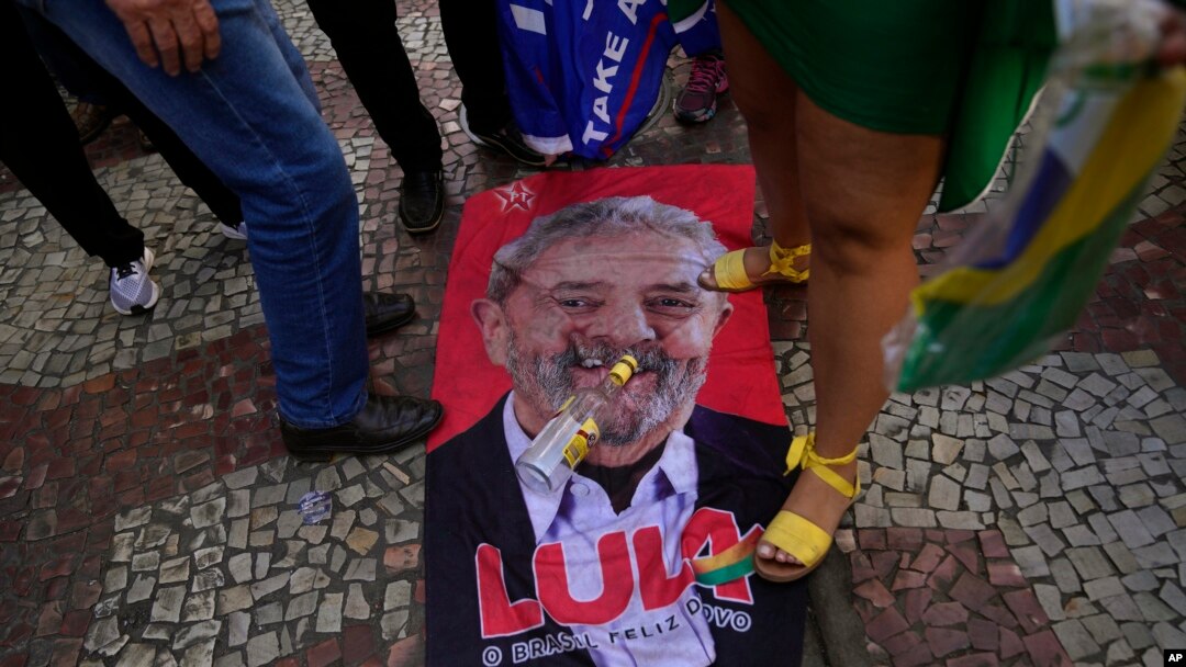 An image of former Brazilian President Luiz Inacio Lula da Silva lays on the ground during a campaign rally for his rival, current President Jair Bolsonaro, in Juiz de Fora, Minas Gerais state, Brazil, Aug. 16, 2022.