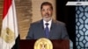 In this image taken from Egypt State TV, newly-elect President Mohammed Morsi delivers a speech in Cairo, Egypt, Sunday, June 24, 2012. In his first televised speech on state TV, Morsi pledged Sunday to preserve Egypt's international accords, a reference