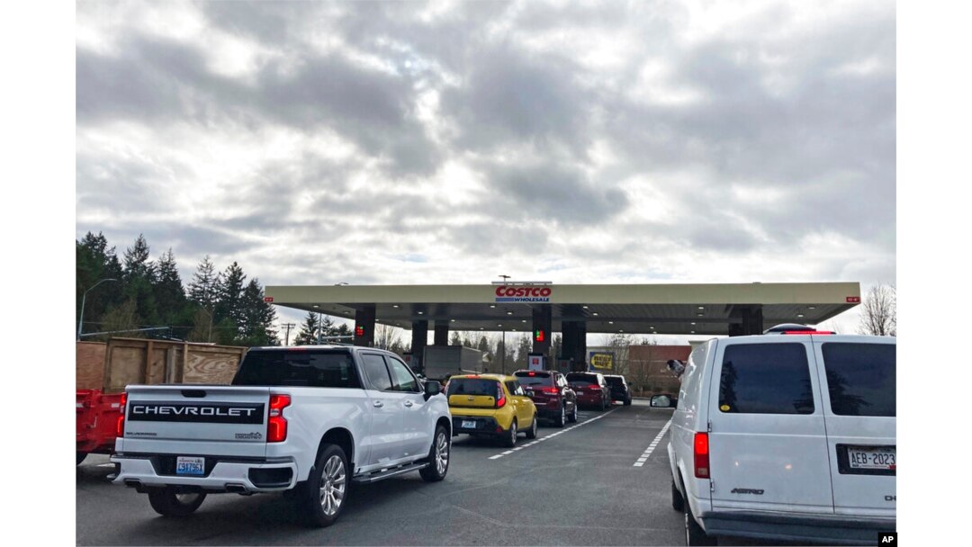 Cars line up for gas at a Costco store in Lacey, Wash., March 7, 2022.