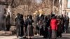 Afghan female university students are stopped by Taliban security personnel next to a university in Kabul, Dec. 21, 2022.