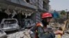 FILE - In this June 23, 2021, file photo, a rescue worker examines the site of explosion in Lahore, Pakistan. A Pakistani official said there is evidence linking India with acts of terrorism in Pakistan.