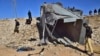 Pakistani security officials inspect a damaged truck at the site of suicide bombing on the outskirts of Quetta, Pakistan, Nov. 30, 2022. The outlawed Tehrik-i-Taliban Pakistan, also known as the Pakistani Taliban, claimed responsibility for the attack