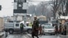 A member of Taliban security force stands guard on a blocked road after a suicide blast near Afghanistan's foreign ministry at the Zanbaq Square in Kabul on Jan.11, 2023. 