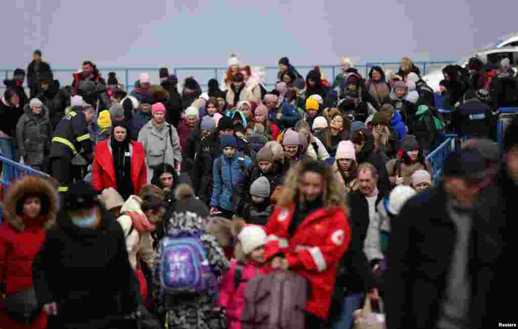 People arrive by ferry after fleeing from Russia's invasion of Ukraine, at the Isaccea-Orlivka border crossing, Romania, March 14, 2022.