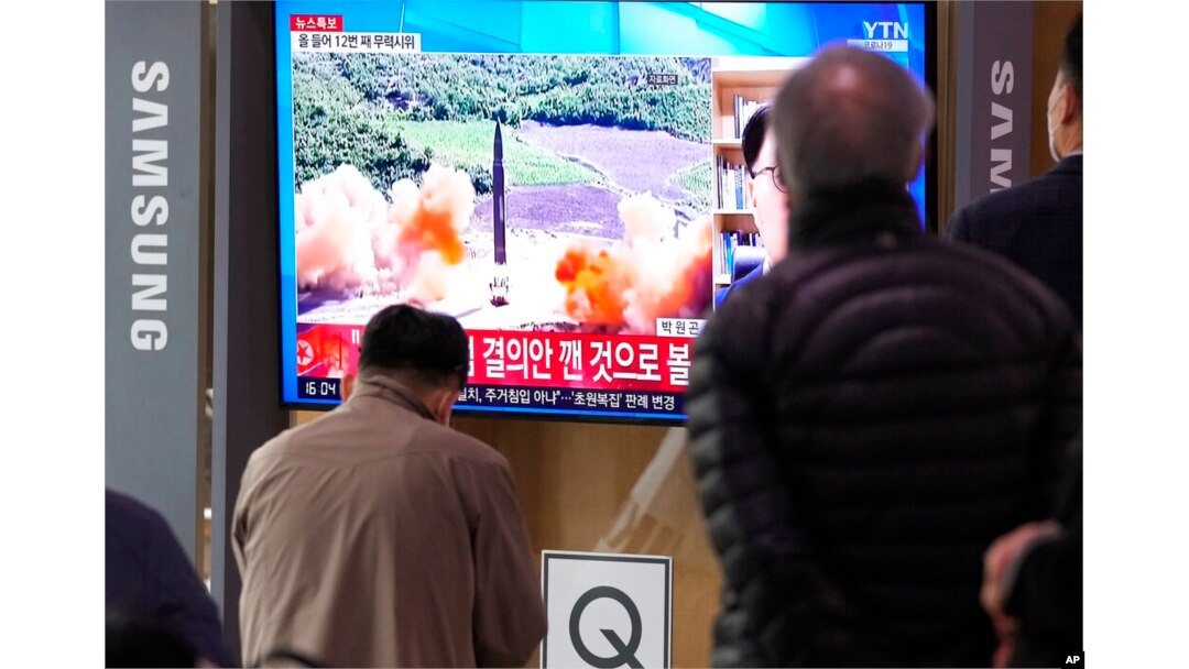 People watch a TV showing a file image of North Korea's missile launch during a news program at the Seoul Railway Station in Seoul, South Korea, March 24, 2022.