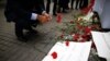 A man leaves carnations at the Saturday explosion site in Istanbul, March 20, 2016. 