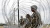 FILE - Members of a U.S Army engineering brigade place concertina wire around an encampment for troops, Department of Defense and U.S. Customs and Border Protection near the U.S.-Mexico international bridge, Nov. 4, 2018, in Donna, Texas.
