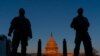 FILE - National Guard soldiers stand their posts around the Capitol at sunrise in Washington, March 8, 2021.