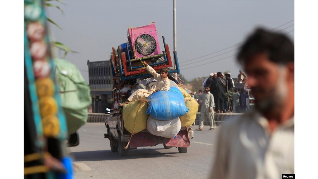 FILE - A man fleeing a military offensive against militants in the Khyber Agency travels on a vehicle laden with his family's belongings on the outskirts of Peshawar in Pakistan's Khyber-Pakhtunkhwa province, Oct. 30, 2014.
