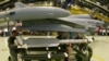 FILE - Technical sergeants of the German Air Force attach a new air-to-air missile IRIS-T (Infraread Imaging System - Tail/Thrust Vector Controlled) on a Eurofighter aircraft at the Fighter wing 73 airforce base in Laage, northern Germany, Dec. 5, 2005. 
