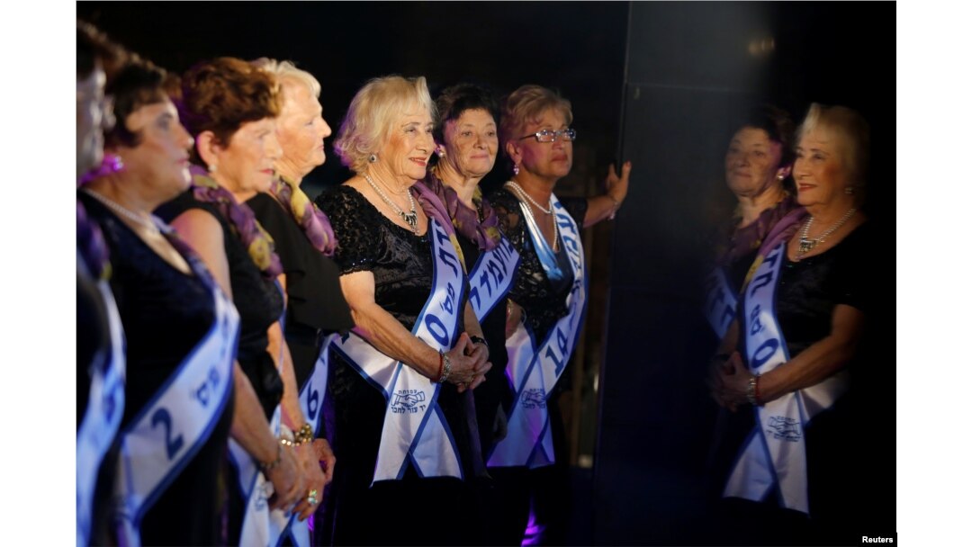 Contestants are reflected in a marble column during the annual Holocaust survivors' beauty pageant in the Israeli city of Haifa, Oct. 30, 2016.