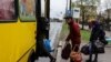 People board a bus leaving Severodonetsk, in eastern Ukraine's Donbass region, on April 13, 2022 as Russian troops intensified a campaign to take the strategic port city of Mariupol, part of an anticipated massive onslaught across eastern Ukraine. 