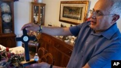 Bob Guerra, a Catholic deacon, holds a crucifix he got to commemorate the visit of Pope Francis to the U.S.-Mexican border at his house in El Paso, Texas, April 3, 2022.