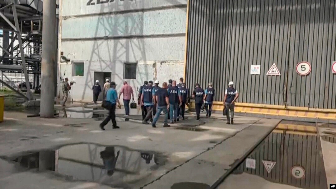 In this handout photo taken from video released by the Russian Defense Ministry Press Service Sept. 2, 2022, members of International Atomic Energy Agency walk while inspecting the Zaporizhzhia Nuclear Power Plant in Enerhodar, southeastern Ukraine, Sept. 1, 2022.