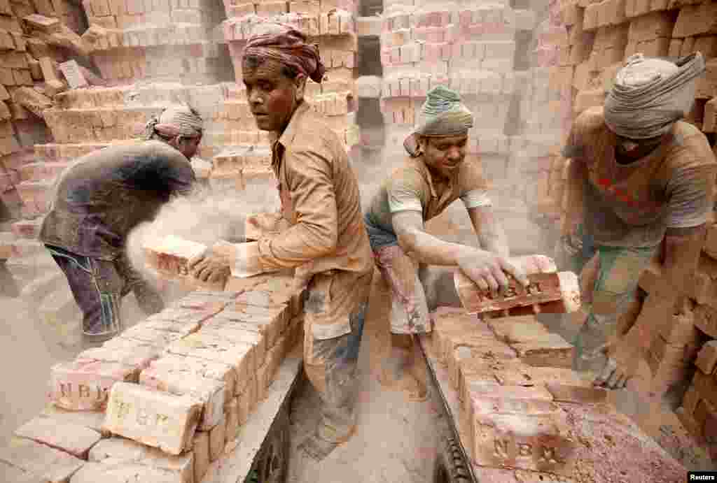 Laborers work at a brick factory in Dhaka, Bangladesh.