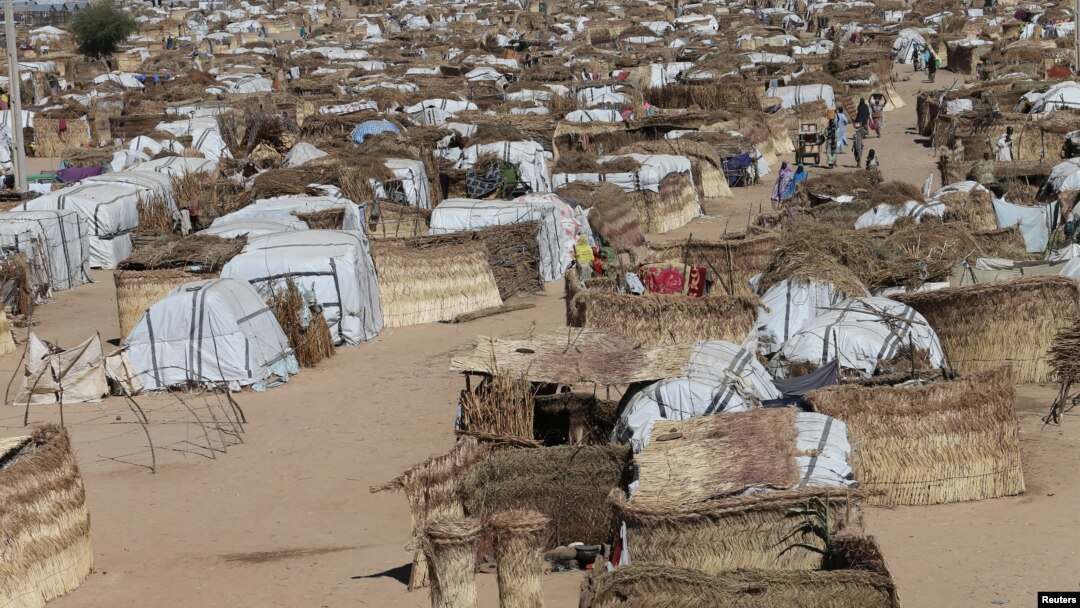 People walk through the United Nations camp in Maiduguri, Nigeria, Dec. 1, 2016. Some 4.6 million people are going hungry across northeast Nigeria, of whom two million need food aid urgently, according to the U.N.