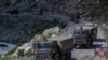 An Indian army convoy moves on the Srinagar- Ladakh highway at Gagangeer, northeast of Srinagar, Indian-controlled Kashmir, Sept. 9, 2020.