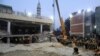 Rescue workers use a crane to lift a portion of a collapsed roof after a suicide blast in a mosque in Peshawar, Pakistan, Jan. 30, 2023.
