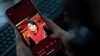 A photo of former Afghan lawmaker Mursal Nabizada who was shot dead by gunmen last night at her house in Kabul is seen on a mobile phone in Kabul, Afghanistan, Jan. 15, 2023.