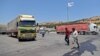 FILE - A convoy transporting humanitarian aid crosses into Syria from Turkey through the Bab al-Hawa border crossing on July 8, 2022. 