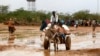 Newly arrived Somali refugees ride a donkey along the street at the Ifo Extension refugee camp in Dadaab, near the Kenya-Somalia border, October 19, 2011.