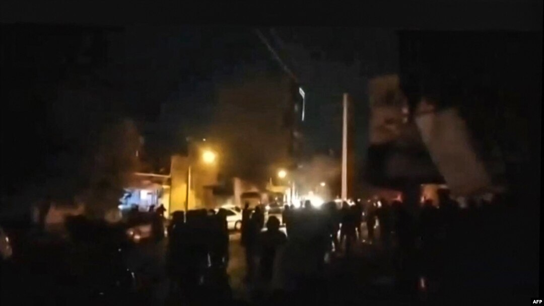 This image grab from UGC video footage made available on the ESN platform through Hengaw Organisation for Human Rights on Nov. 16, 2022, reportedly shows Iranian protesters surrounding the municipality building in the western Kurdish-majority city of Buk