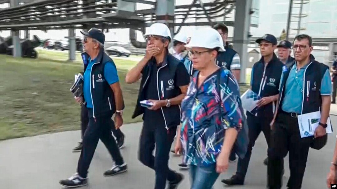 In this handout photo taken from video released by Russian Defense Ministry Press Service on Sept. 2, 2022, International Atomic Energy Agency (IAEA) director Rafael Grossi, center, and IAEA members walk while inspecting the Zaporizhzhia nuclear power pla
