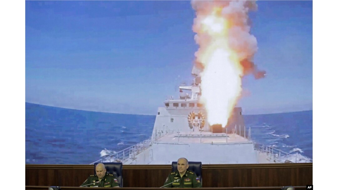 Colonel General Sergei Surovikin, commander of the Russian forces in Syria, left, and Colonel General Sergei Rudskoi of the Russian General Staff attend a briefing in the Russian Defense Ministry in Moscow, June 9, 2017. A screen in the back shows a Russian navy's Admiral Essen frigate launching a cruise missile at the Islamic State in Syria.