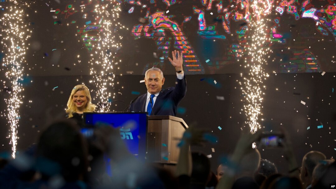 Israel's Prime Minister Benjamin Netanyahu, accompanied by his wife Sara, waves to his supporters after polls for Israel's general elections closed in Tel Aviv, Israel, April 10, 2019.