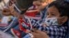 A U.S. Border Patrol Agent removes a wristband from Santiago, a 4-year-old asylum-seeking migrant boy from Honduras, after he crossed the Rio Grande River into the U.S. from Mexico with his mother, in Penitas, Texas, March 9, 2021.