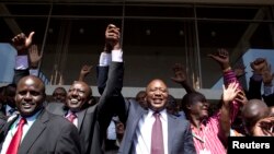 Kenya's presidential candidate Uhuru Kenyatta (C) and his running mate William Ruto (2nd L) celebrate winning the presidential election with supporters after the official result was released in Nairobi, March 9, 2013. 